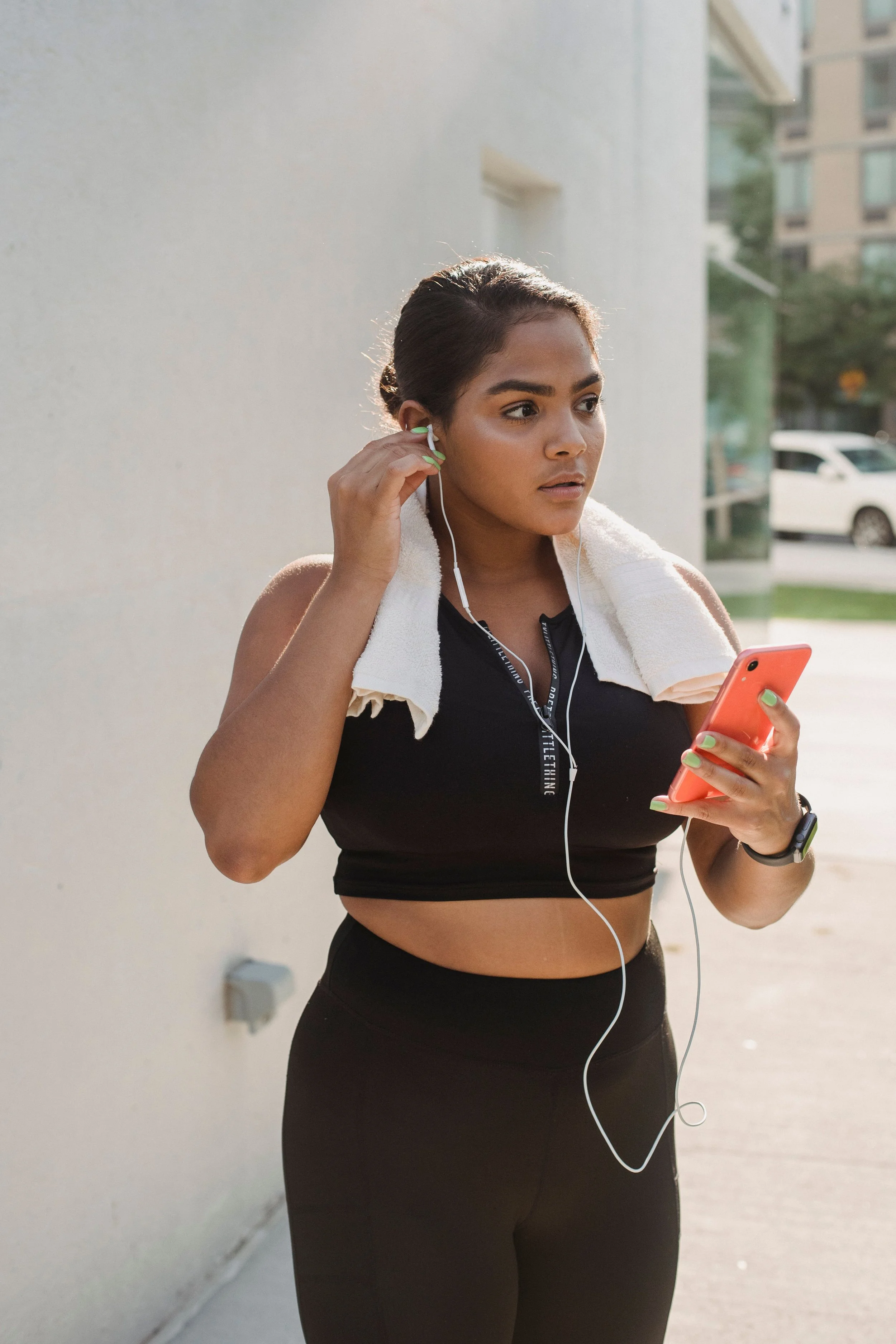 Woman pausing on an outdoor walk representing a trauma-informed approach to movement and nervous system regulation