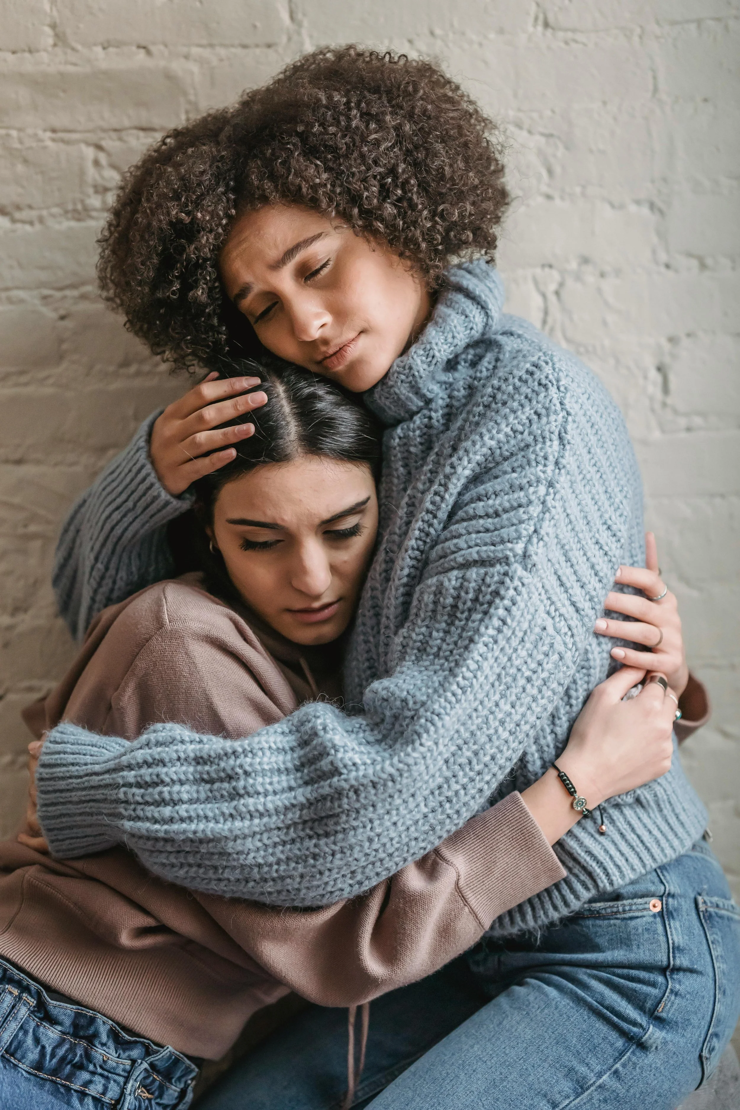 Two women embracing in a moment of emotional support, reflecting therapy for grief, loss, and life transitions