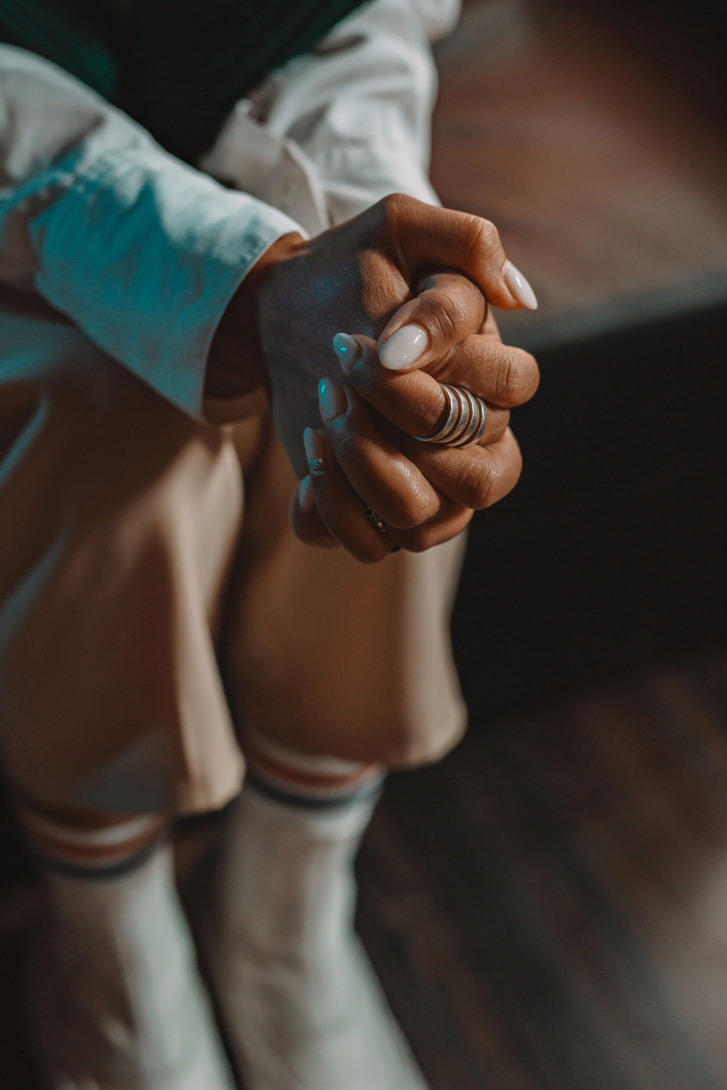 Close-up of a woman's hands conveying physical tension, representing how chronic stress is held in the body