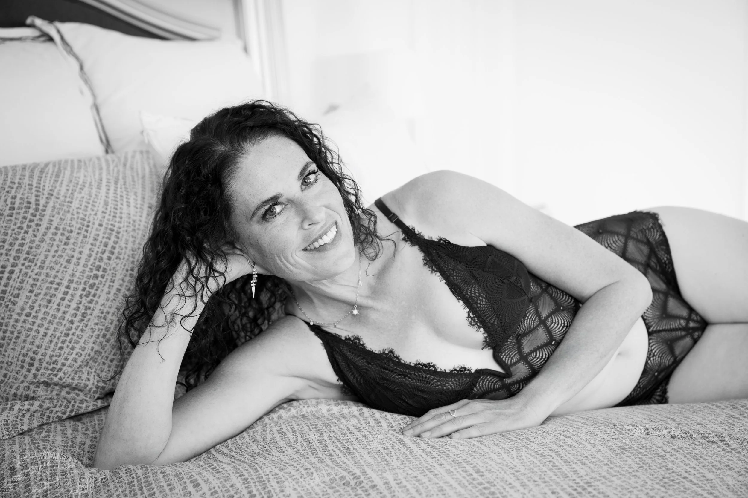 Woman lounging in lingerie, her body language open, confident, and unedited, Long Island, NY. 