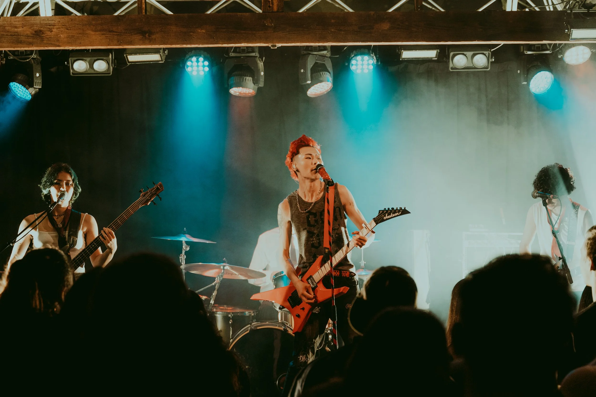 Kevin Silvester performing with his band and red guitar at the Bergy