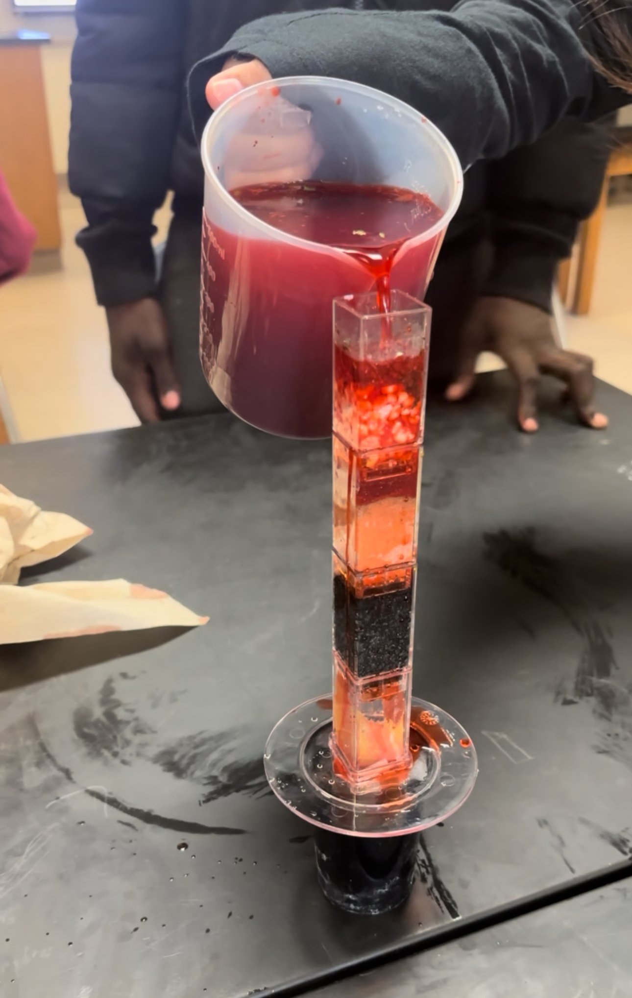 Pouring solution into water filtration system