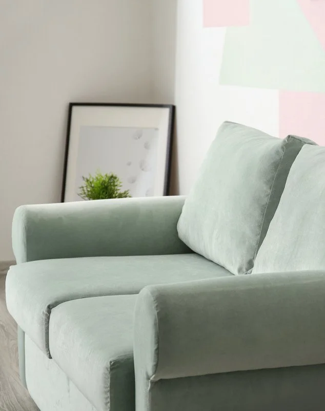 A green chair with a picture next to it