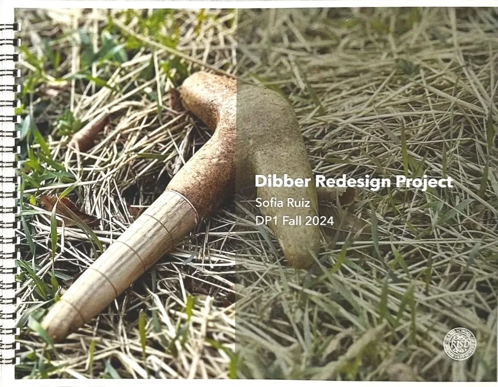 A garden dibber lying on dry grass and green weeds, with text overlay indicating a project titled 'Dibber Redesign Project' by Sofia Ruiz for DP1 Fall 2024.