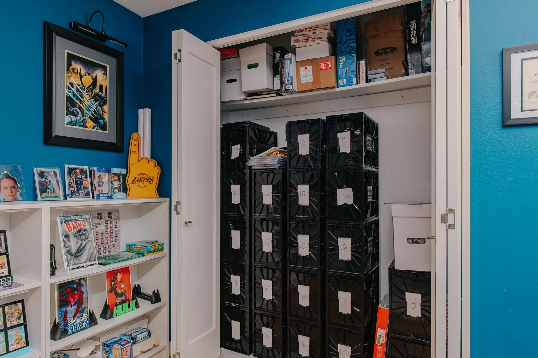 Black crates filled with comic books stacked high inside the owner's crowded studio closet.