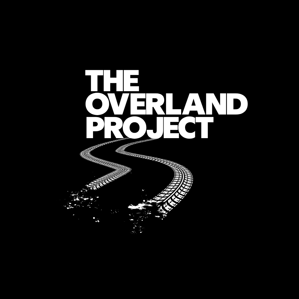 Black and white design with the text 'The Overland Project' and an illustration of a winding train track.
