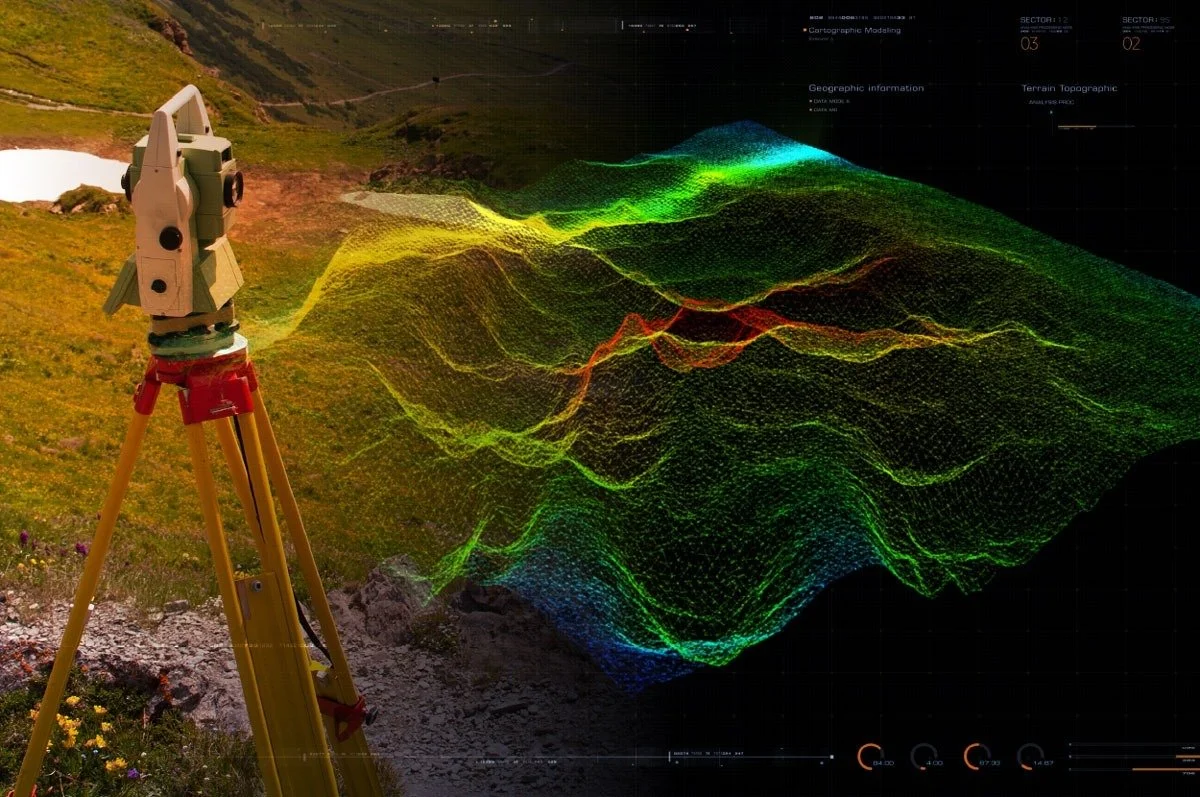 Surveying equipment on a tripod looking at a digital 3D terrain model of a mountainous landscape.