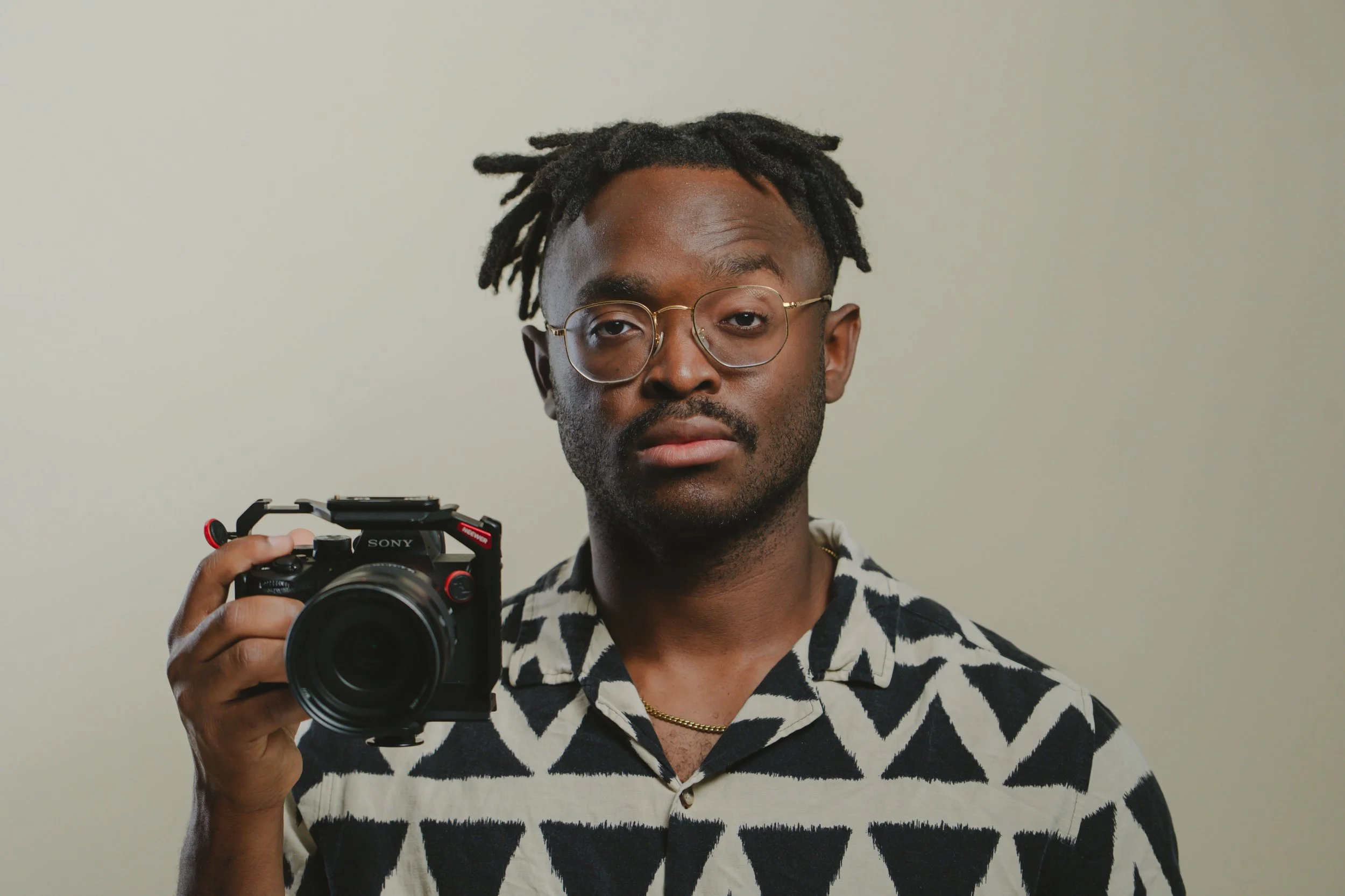 imani lenz holding a camera smiling