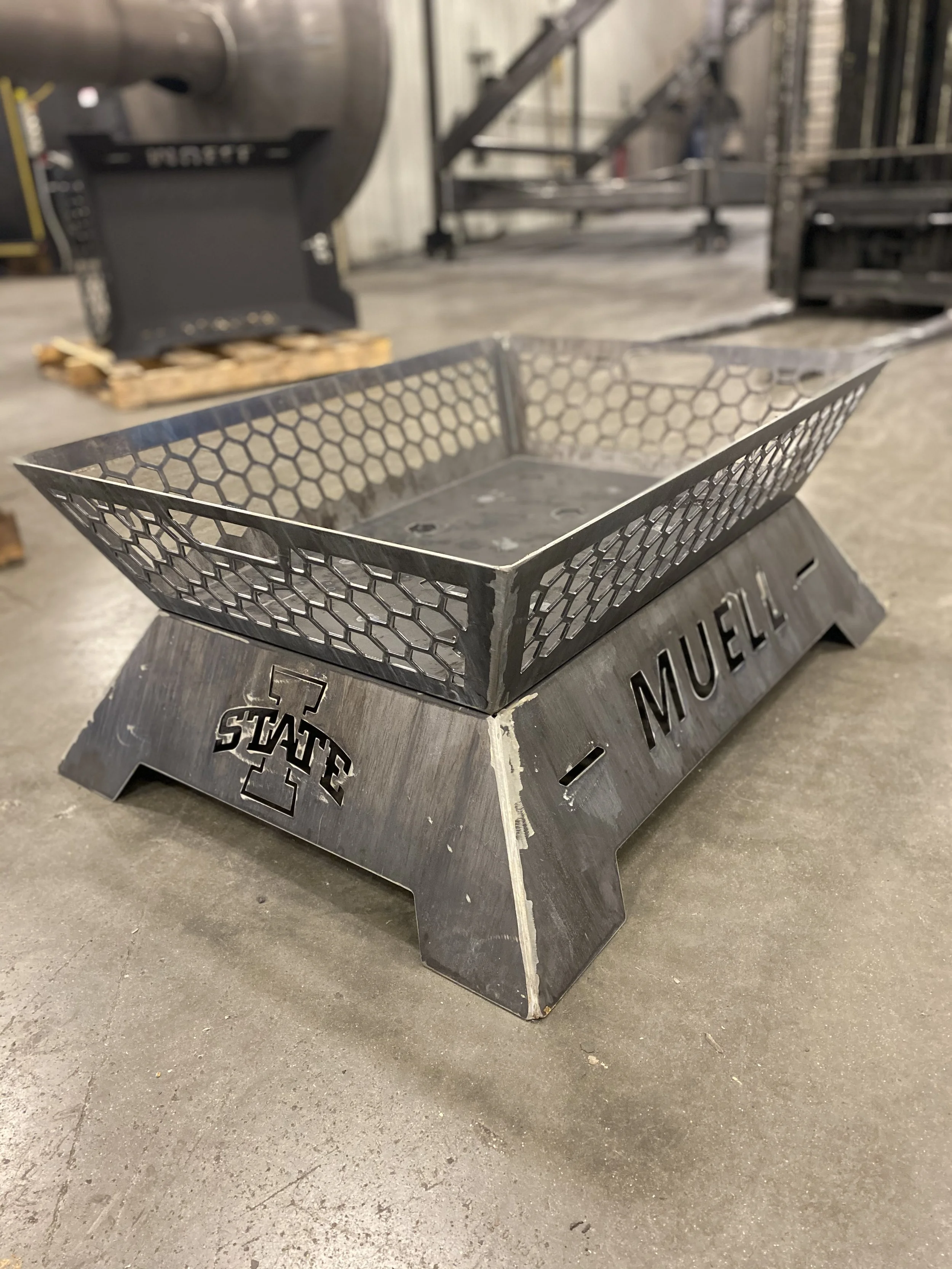 A custom metal firepit with an industrial finish and unique look