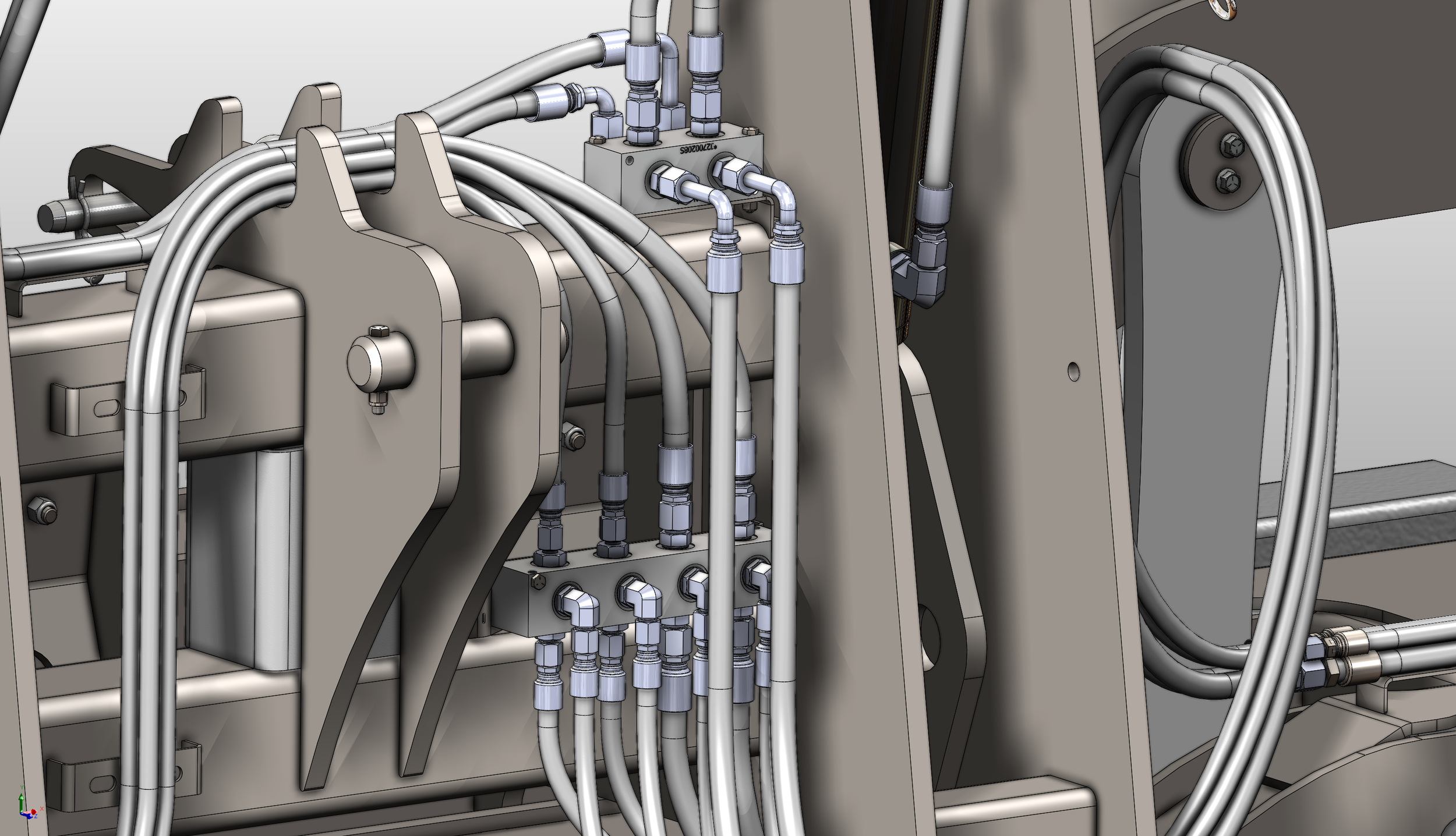 Close-up of interconnected metal pipes and fittings, part of a mechanical or hydraulic system.