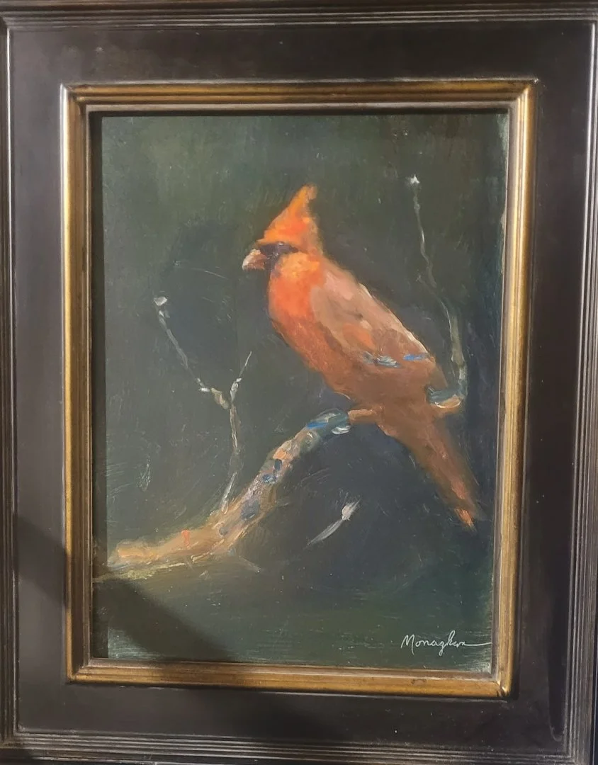 Oil painting of a cardinal bird perched on a branch, signed by Monaghan.