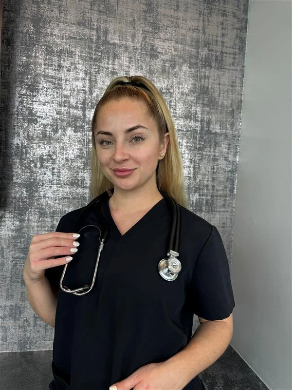 Young woman in black scrubs with a stethoscope