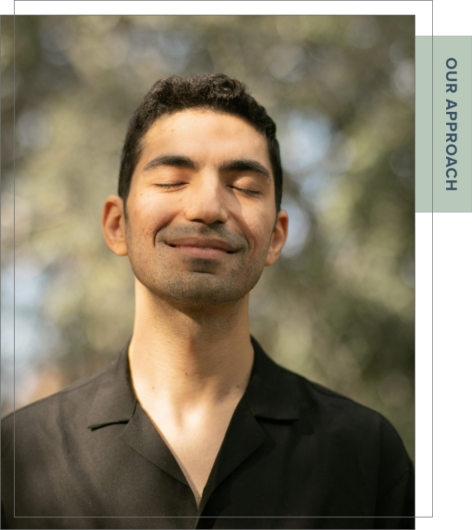 man smiling outdoors in dappled light