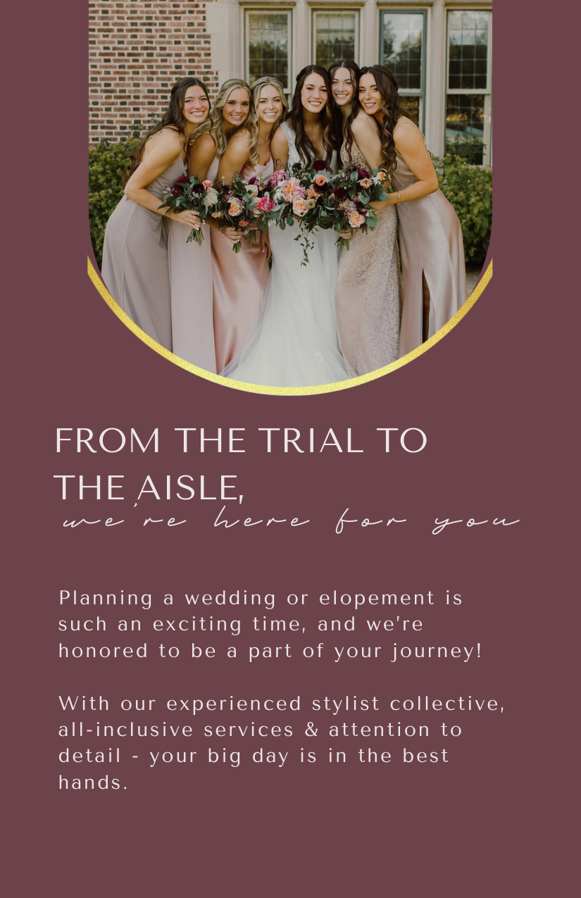 Group of six women, dressed in bridesmaid gowns, standing outdoors in front of a house with brick and large windows, holding bouquets of flowers, smiling for the photo.