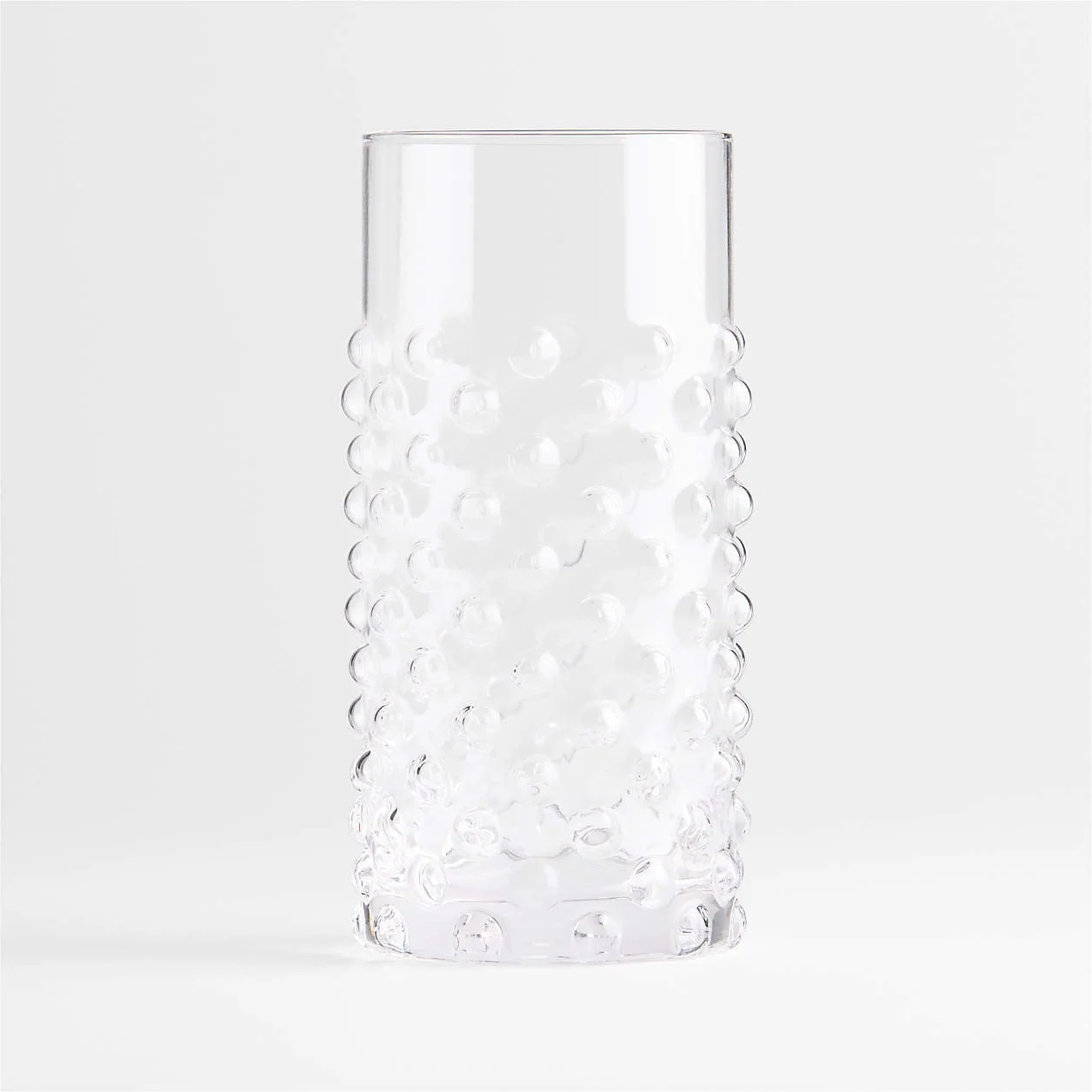 A tall, transparent glass vase with a textured surface of raised bubbles, set against a plain white background.