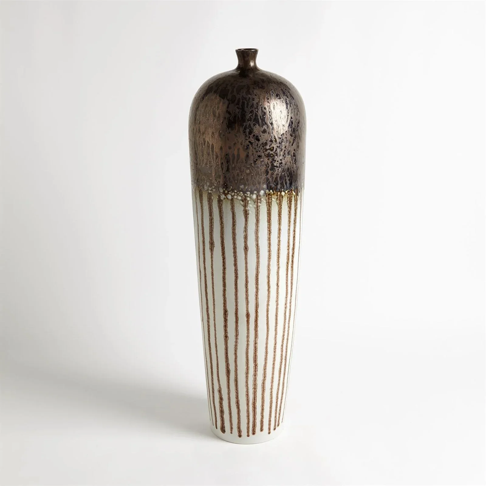 Tall ceramic vase with a two-tone glaze, dark brown on the top half and white with vertical brown drips on the bottom half, set against a plain white background. interior decor, vase