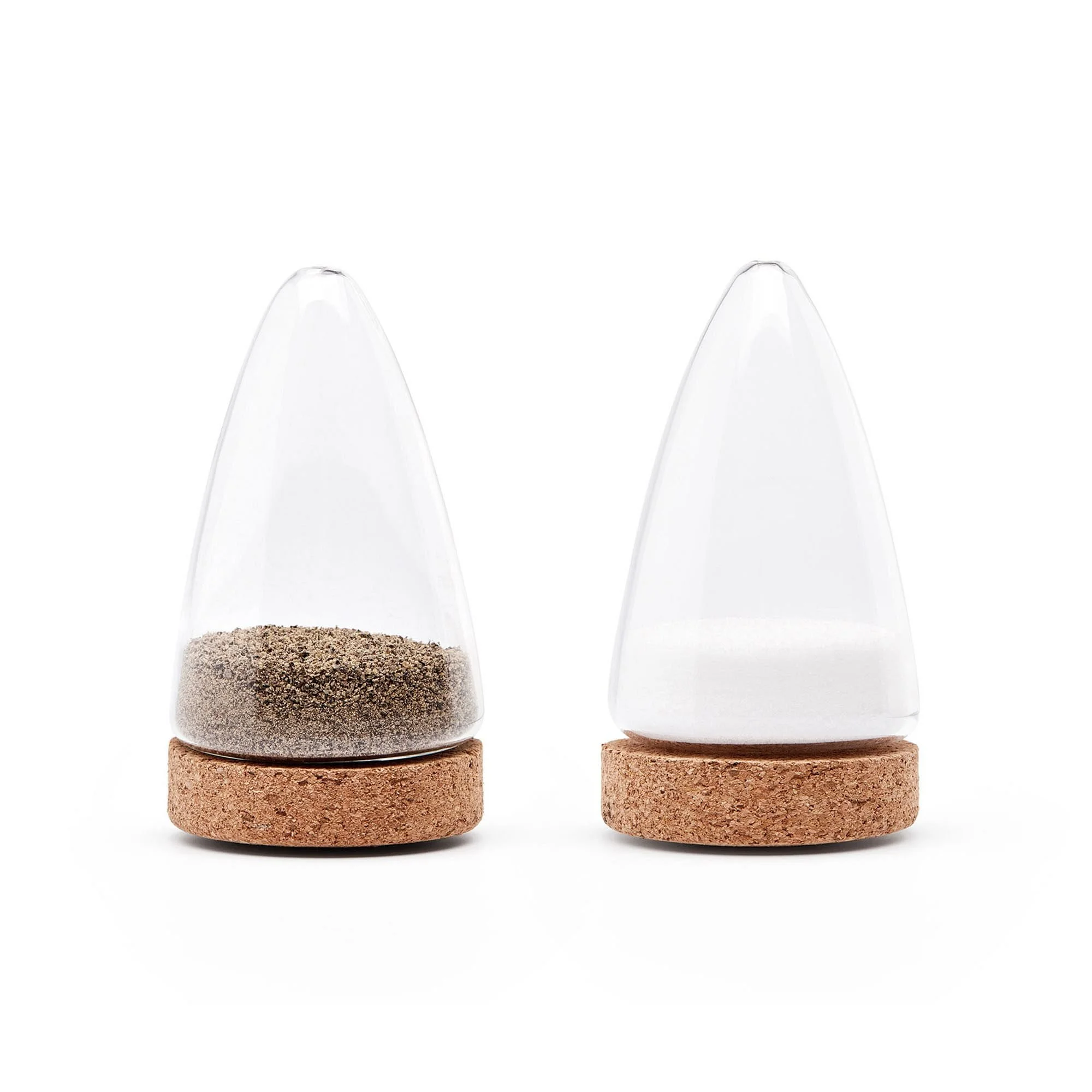 Salt and pepper shakers on cork coasters against a white background.