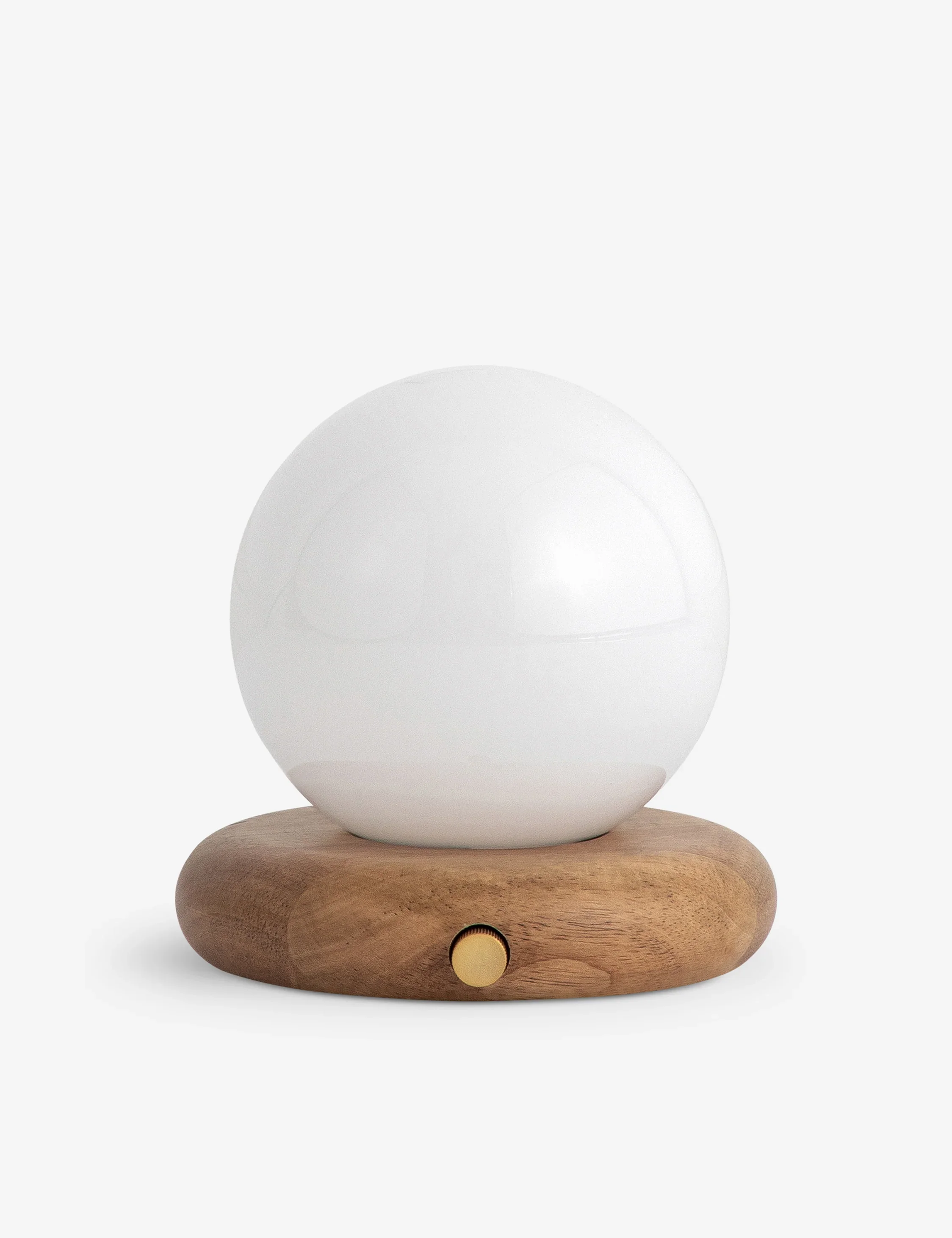 A white cordless spherical light on a round wooden base with a small gold knob, decorative lamp