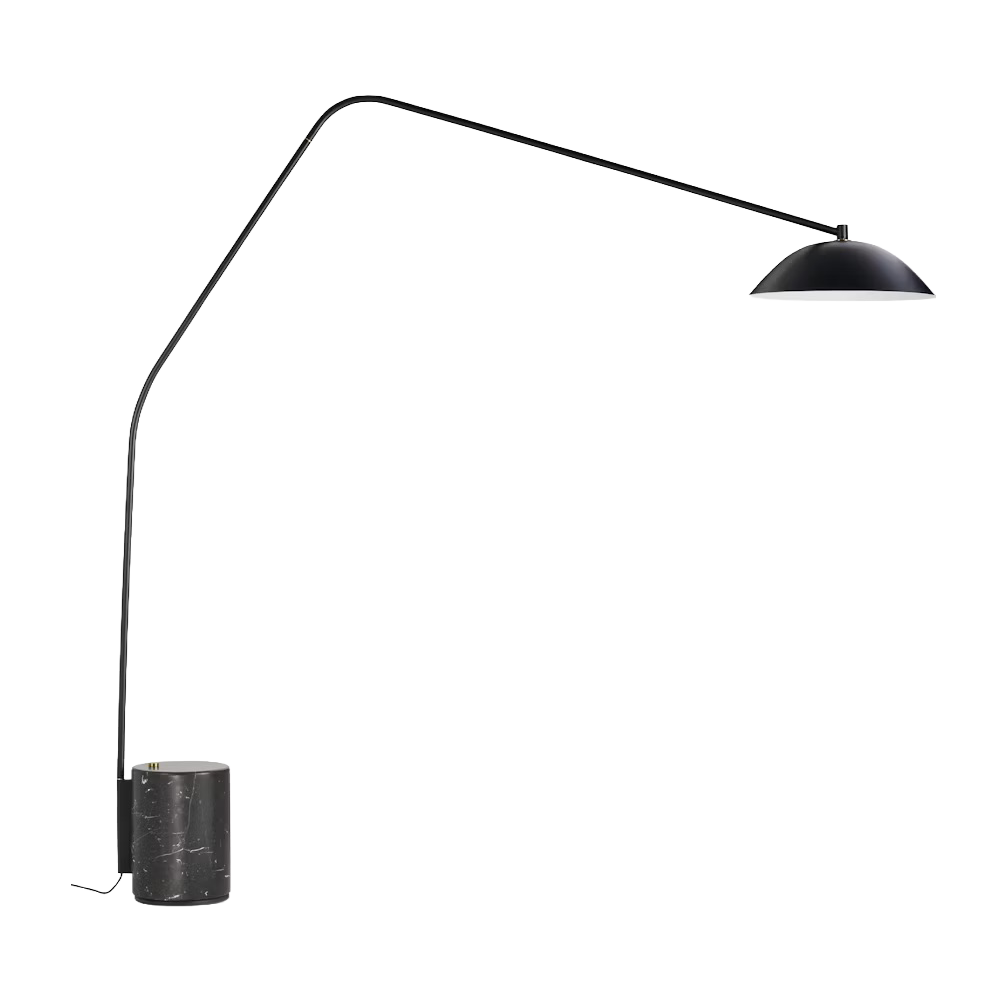 A modern photography or video studio setup with a large white backdrop, overhead studio light, and a black cylindrical stand or speaker on the left.