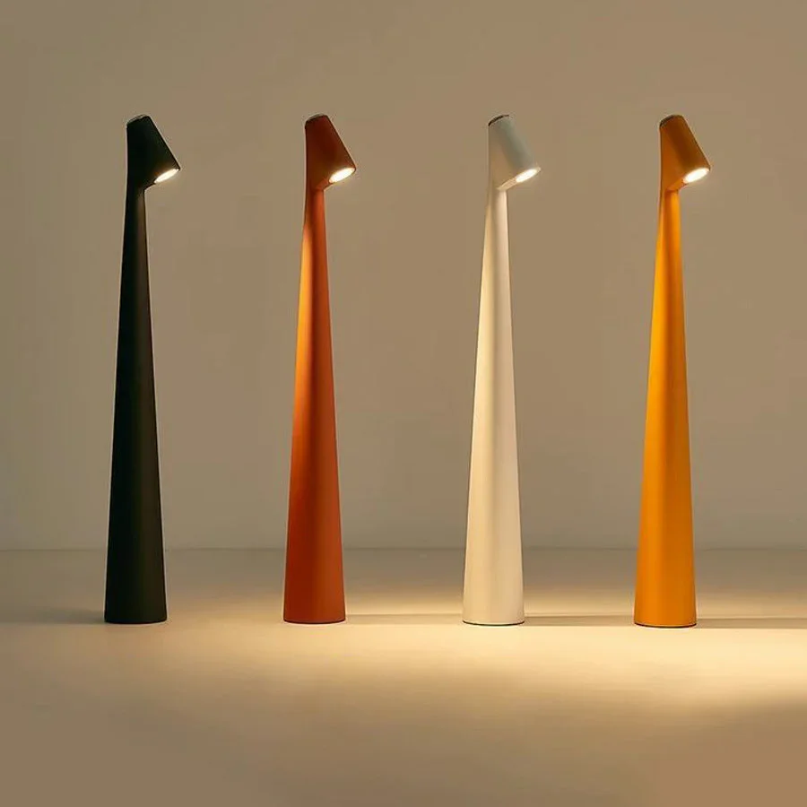 modern cordless table lamps with different colored —black, red, white, and yellow casting light downward.
