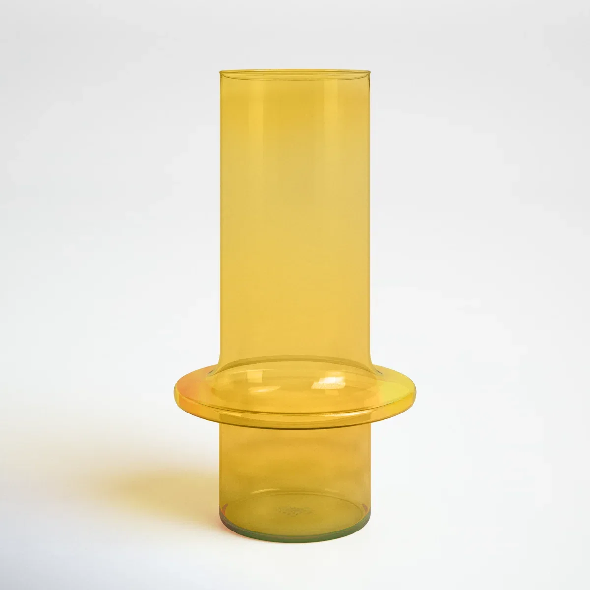 Yellow glass vase with a tall, cylindrical shape and a wide, flat circular opening.