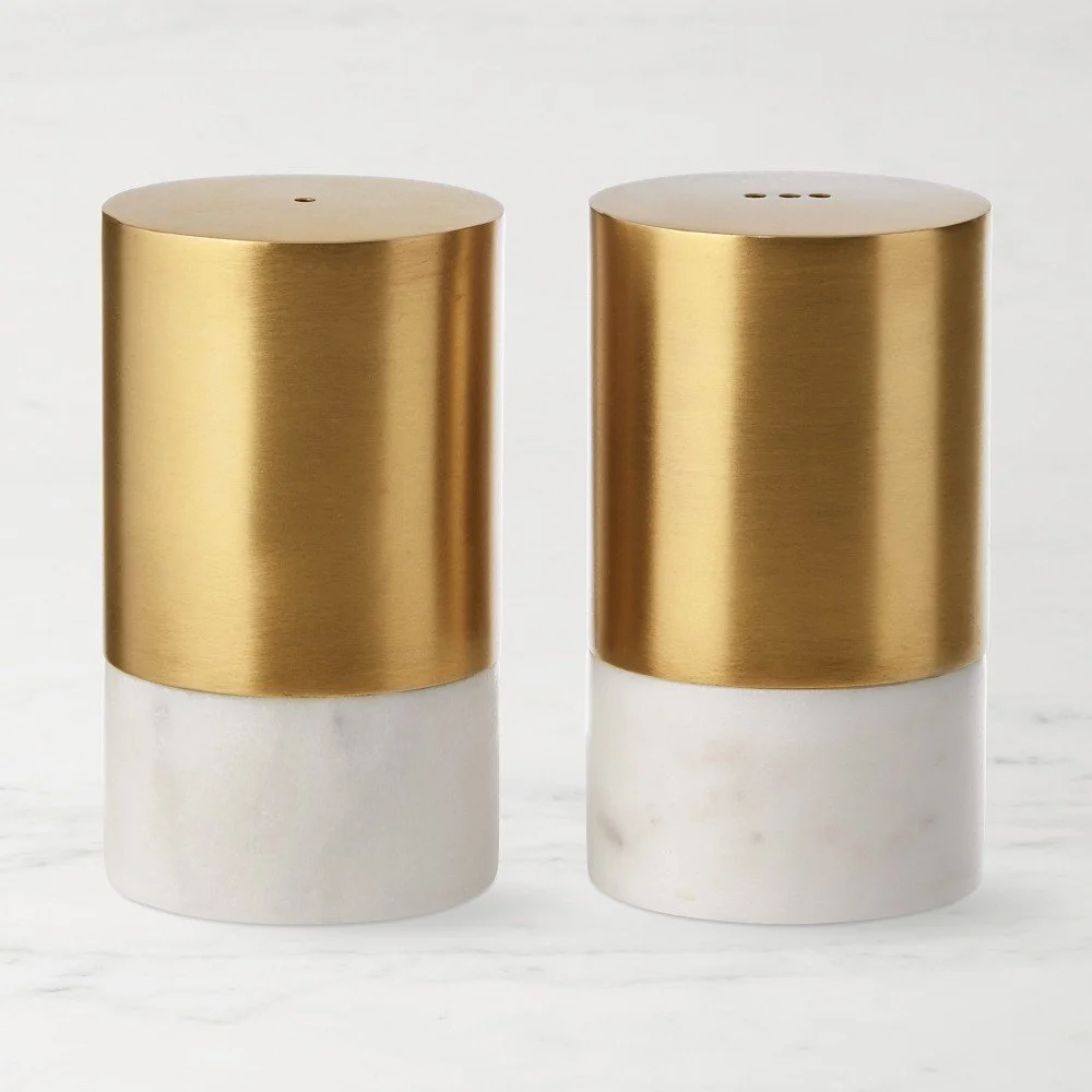 Two salt and pepper shakers with gold and white marble design