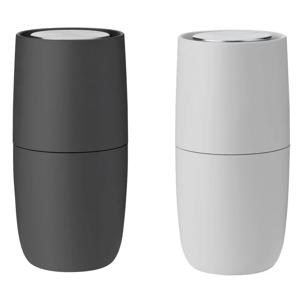 Two modern, sleek, salt and pepper grinders one black and one white.
