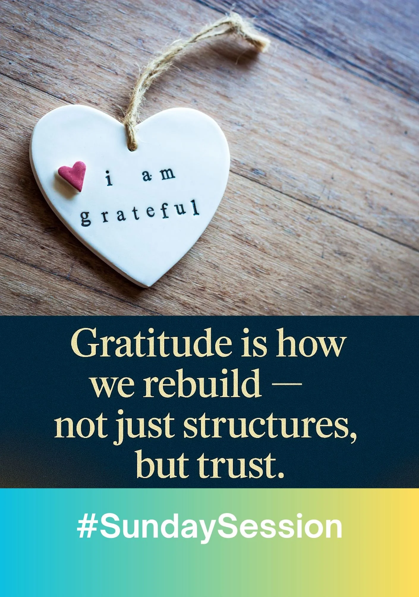 A white heart-shaped ornament on a wooden surface with a small pink heart and the words "i am grateful" written on it. Below, a quote reads: "Gratitude is how we rebuild — not just structures, but trust." A hashtag #SundaySession is at the bottom on 