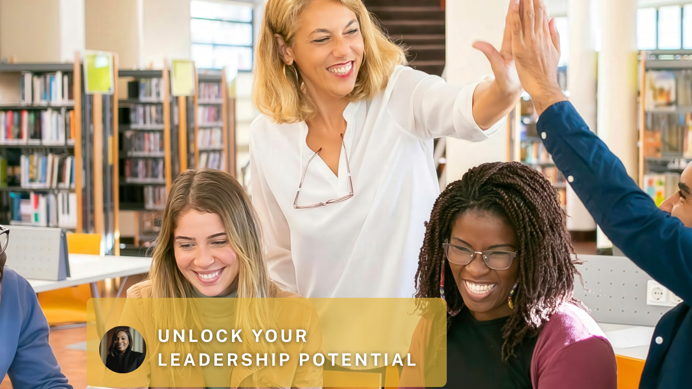 A woman giving a high five to a man during a group meeting in a library or office setting, with two women smiling at the table, promoting leadership potential.