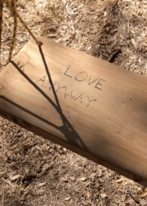 Video by Little Door. Wooden swing swaying with the words 'LOVE ANYWAYS' written on it.