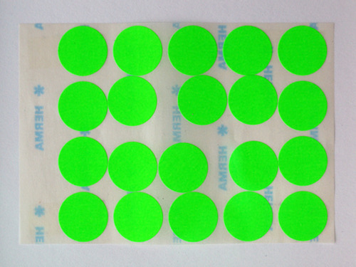 Sheet of bright green round stickers arranged in a 4 by 5 grid on a white backing sheet.