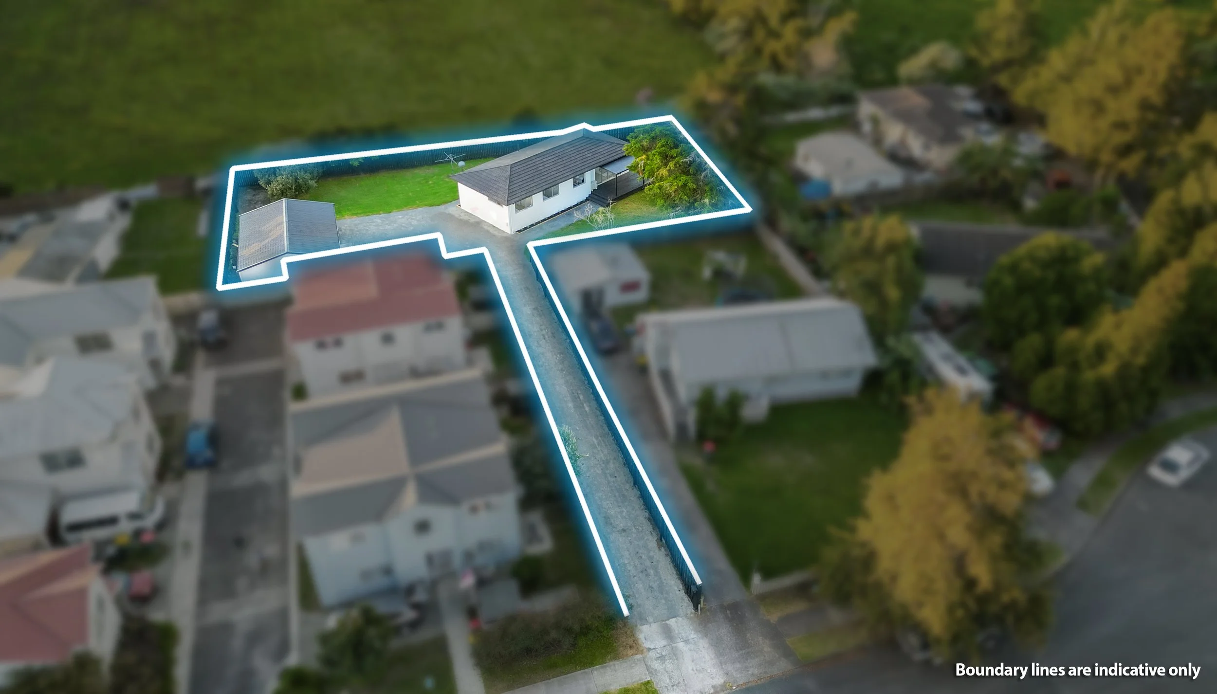 Aerial view of a house with boundary lines indicating property limits, gravel driveway, neighboring houses, trees, and a grassy yard.