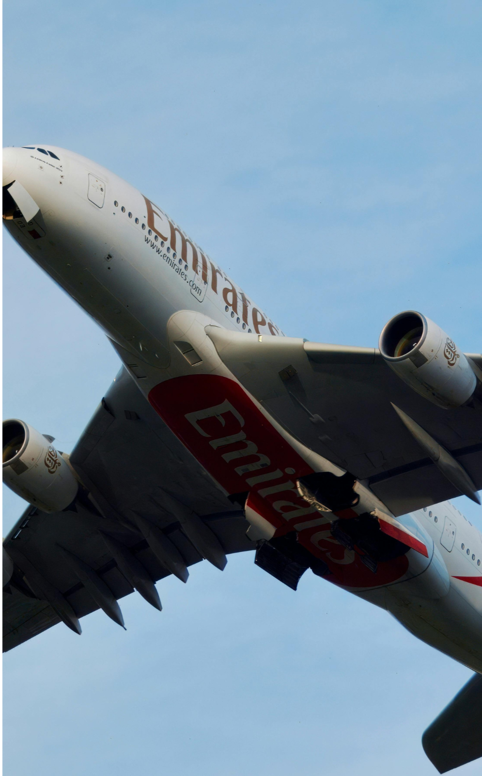 Emirates airline aircraft in flight, indicating strategic partner alignment