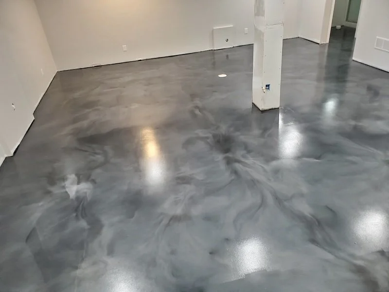 Empty room with newly finished gray marble-like metallic epoxy polished concrete floor.