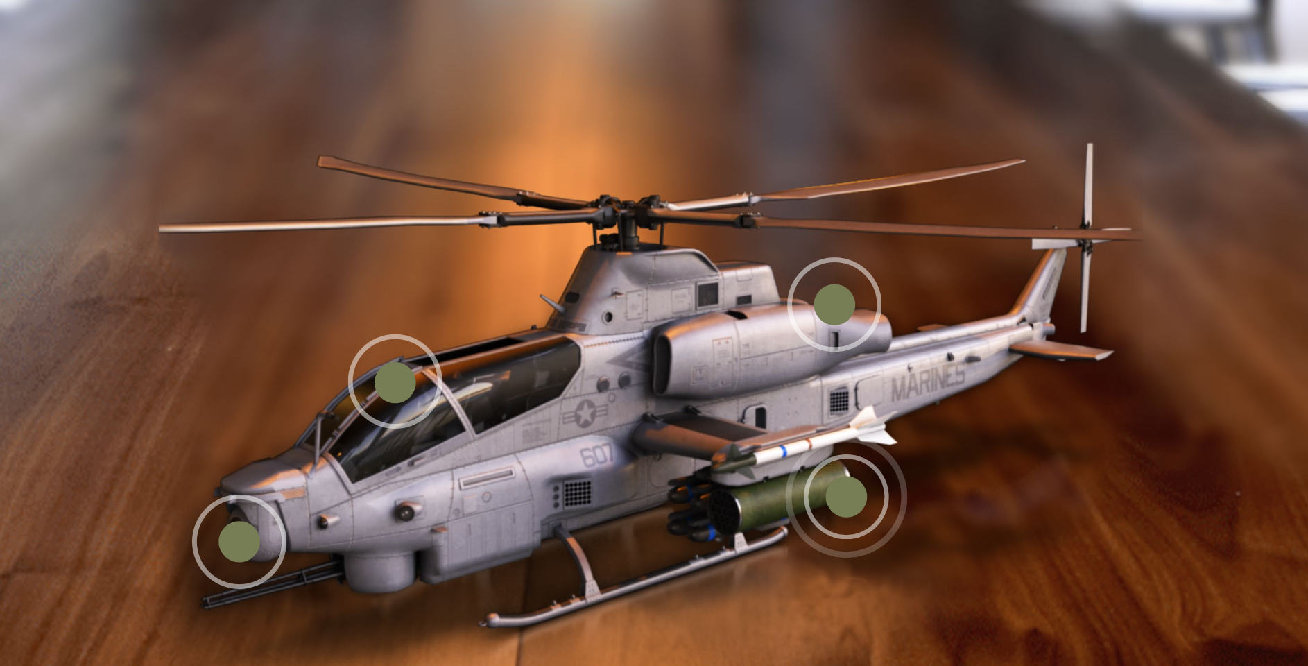 A military helicopter flying over a desert landscape with a brown and orange terrain, with four labeled points of interest highlighted.