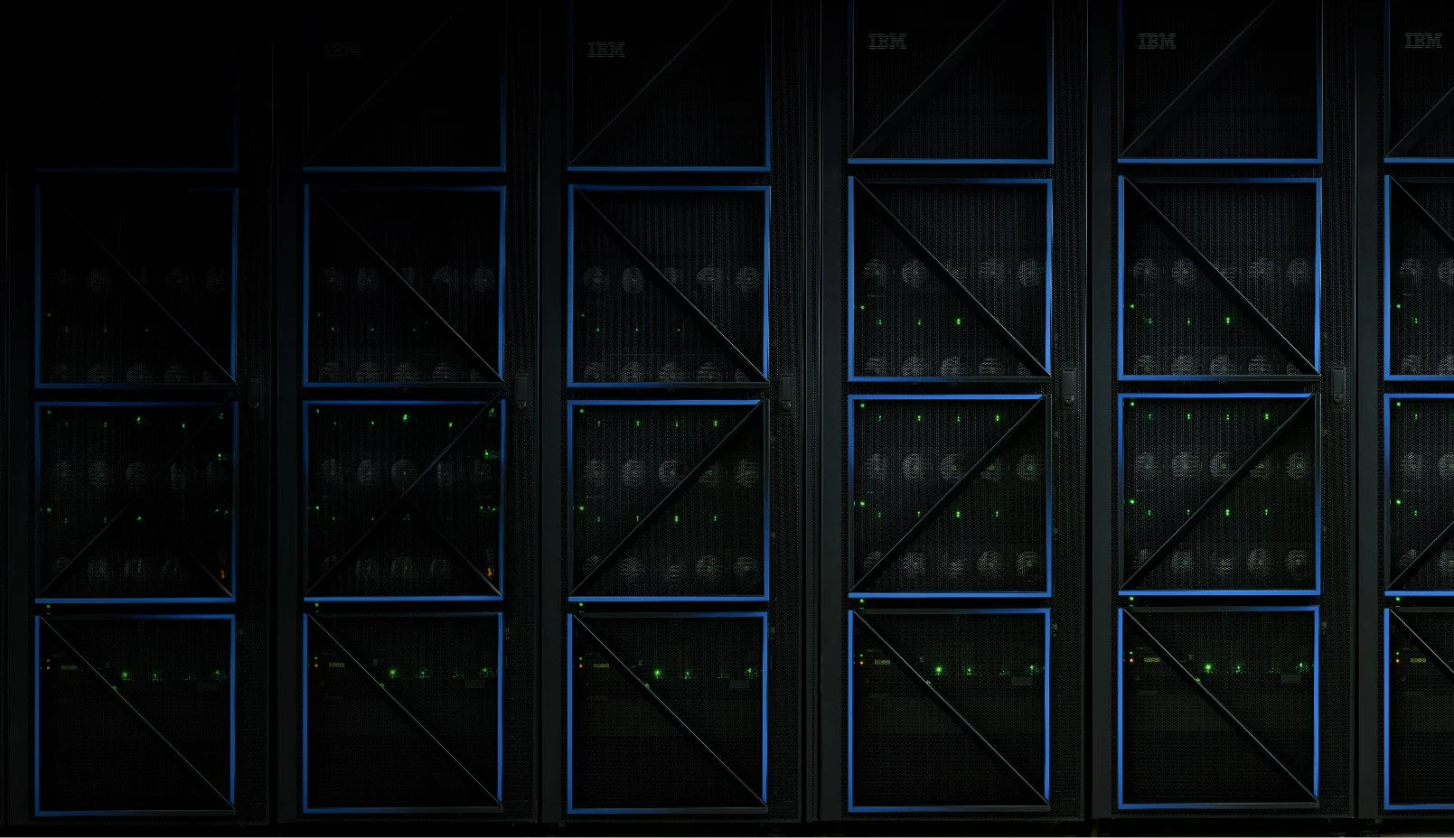 A row of black server racks with blue edges, filled with blinking green and white indicator lights.