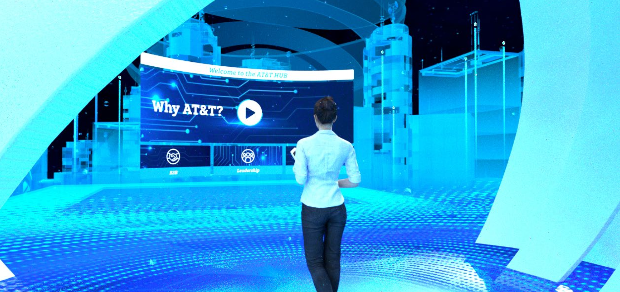 A woman walking towards a digital display at the AT&T HUB with a sign that says 'Why AT&T?' and icons for B2B and leadership.