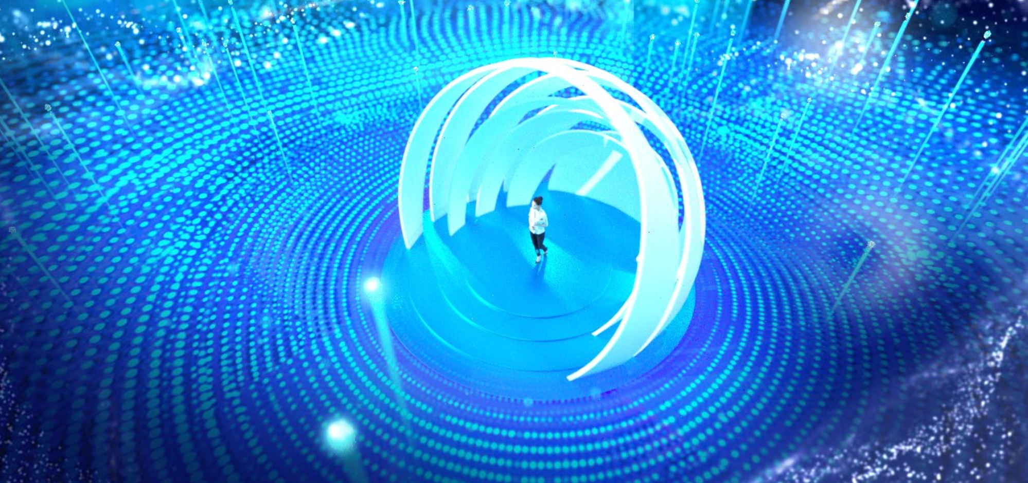 A person walking through an illuminated blue tunnel with bright blue and white glowing rings and dotted patterns.