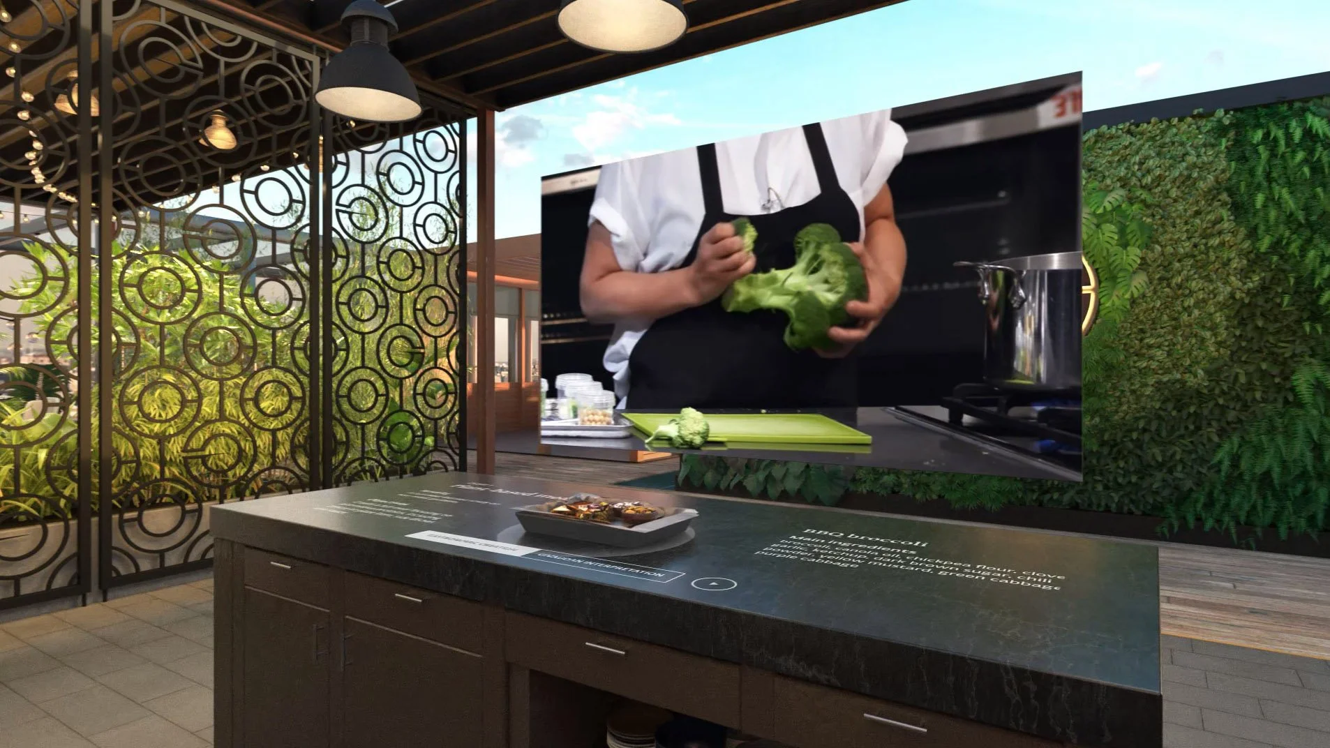 Outdoor restaurant or cafe with decorative metal partitions, overhead pendant lights, and a green wall. A person in a white apron and black shirt holds broccoli in front of a stove.