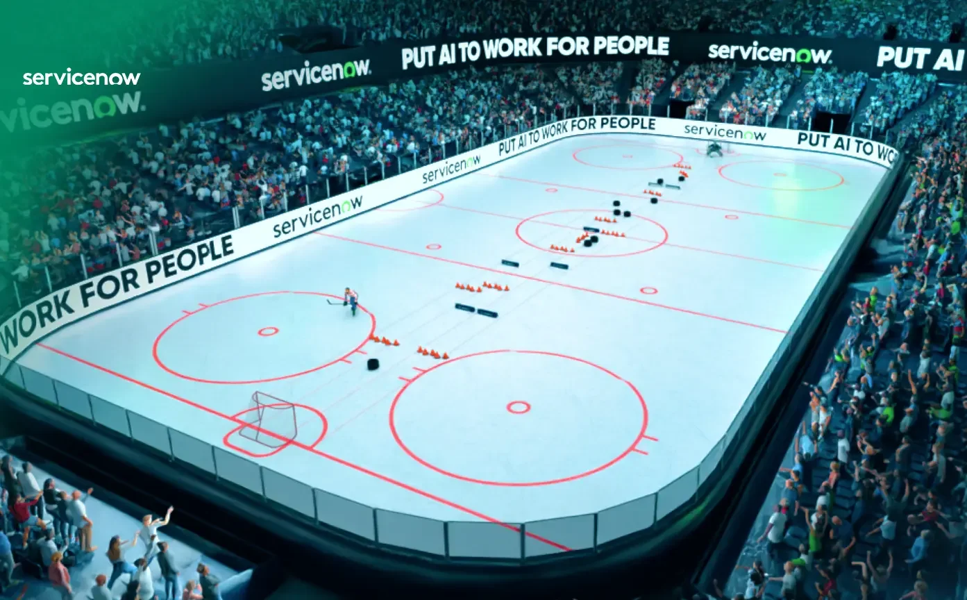An indoor ice hockey rink filled with spectators, with advertising boards around the ice, displaying messages such as 'service now' and 'PUT AI TO WORK FOR PEOPLE'. The rink has hockey goals, face-off circles, and various training equipment arranged on the ice.
