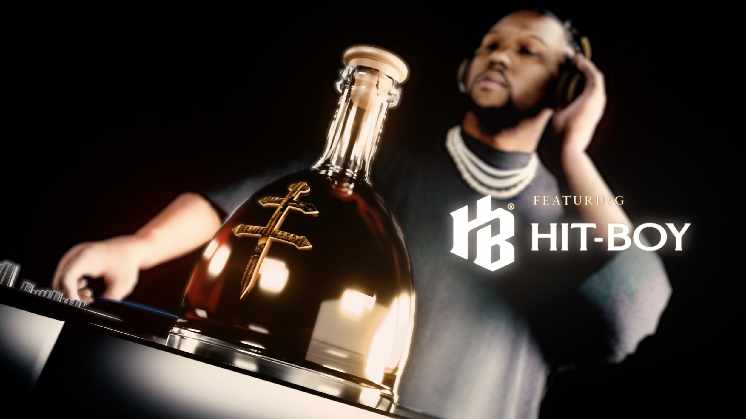 A man wearing headphones and jewelry looking at a gold bottle with a cross emblem, with text 'Featuring Hit-Boy'.