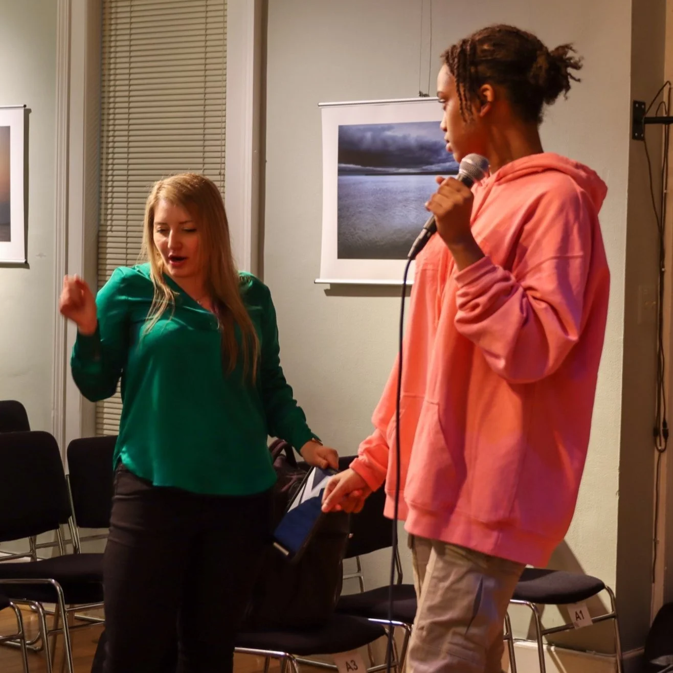 SwC-F24 CC AA Dress Rehearsal-126 demonstrating holding mic with cece.jpg