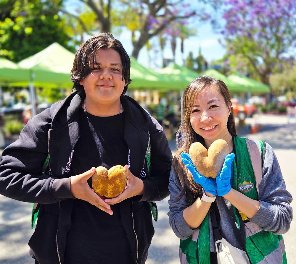 Volunteers smiling at food drive site