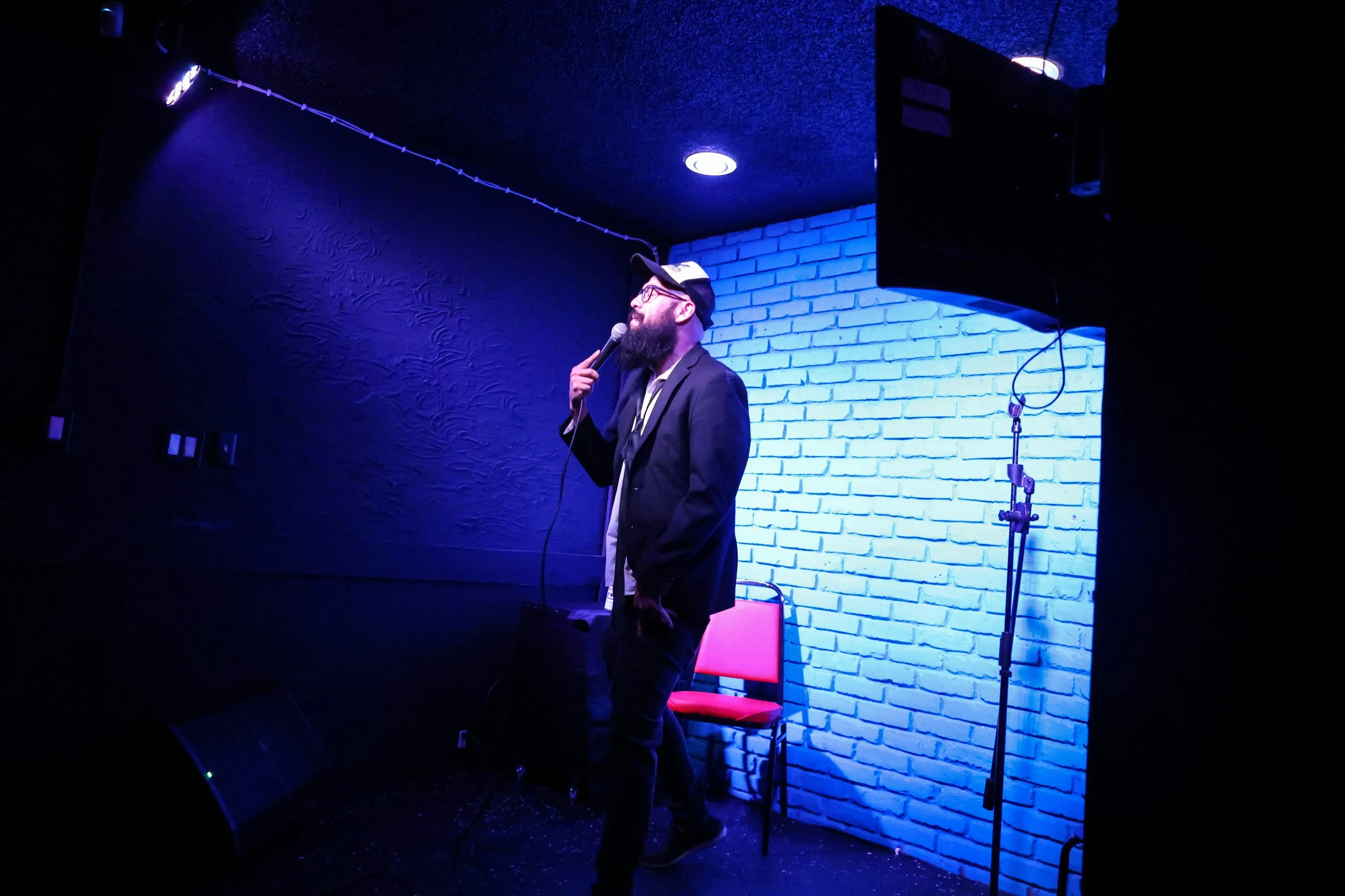 Our intimate stage has a TV, multiple mics, and stage lighting