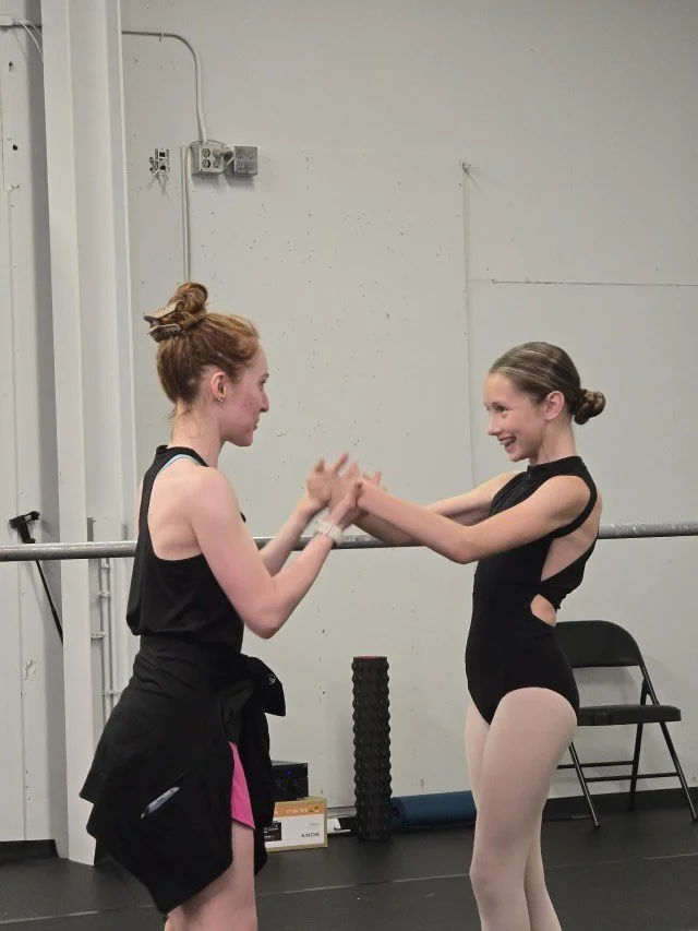 Megan Lynch sharing a warm teaching moment with a BalletCorps student