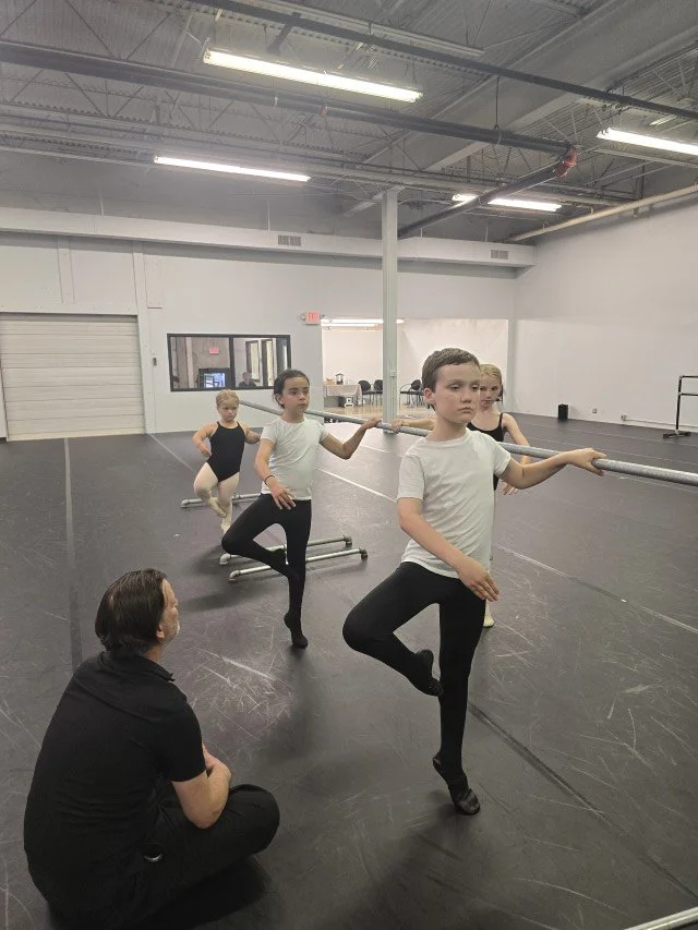 Logan Pachciarz coaching BalletCorps junior dancers in center