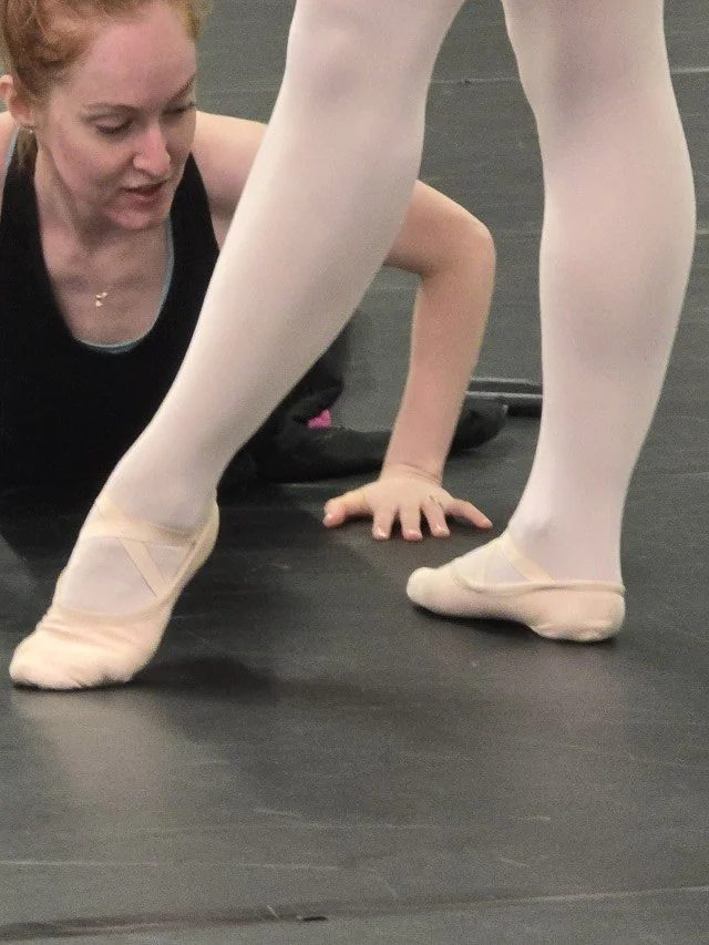 Megan Lynch closely observing a BalletCorps student’s foot placement and turnout
