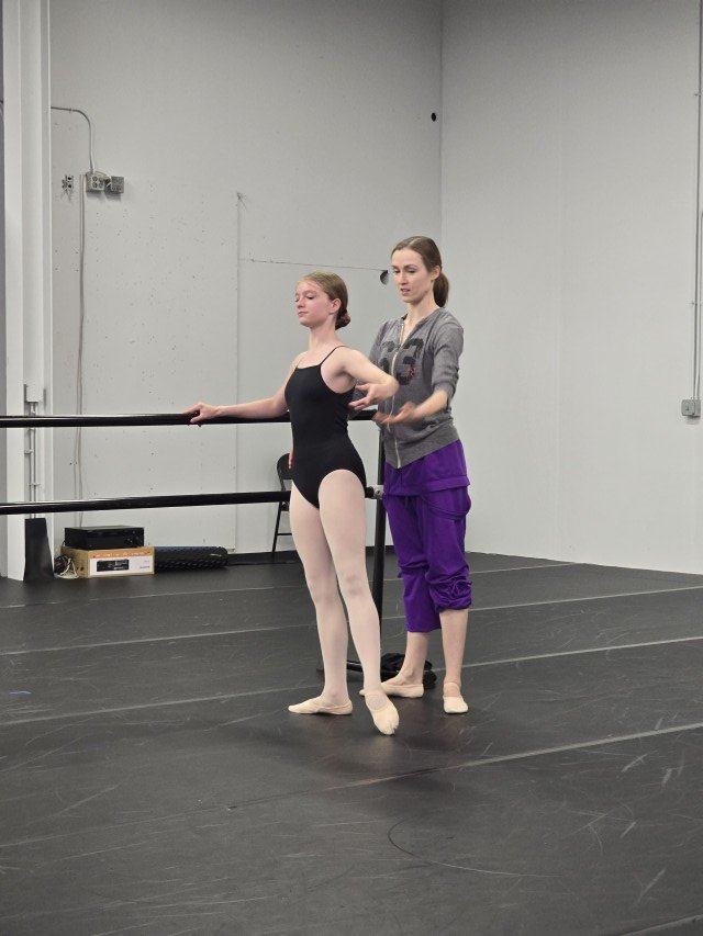 Kimberly Uphoff Spencer giving a detailed technical correction to a BalletCorps student