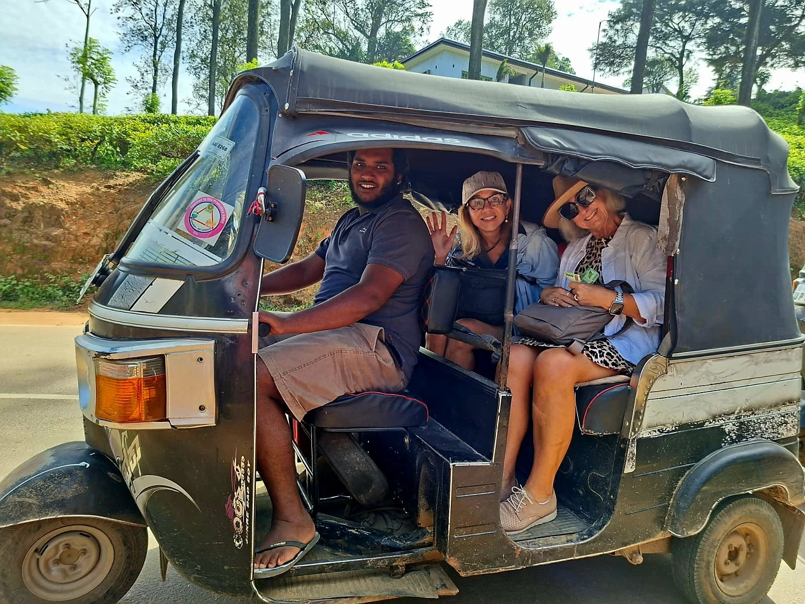 Two women and a driver in a tuk tuk