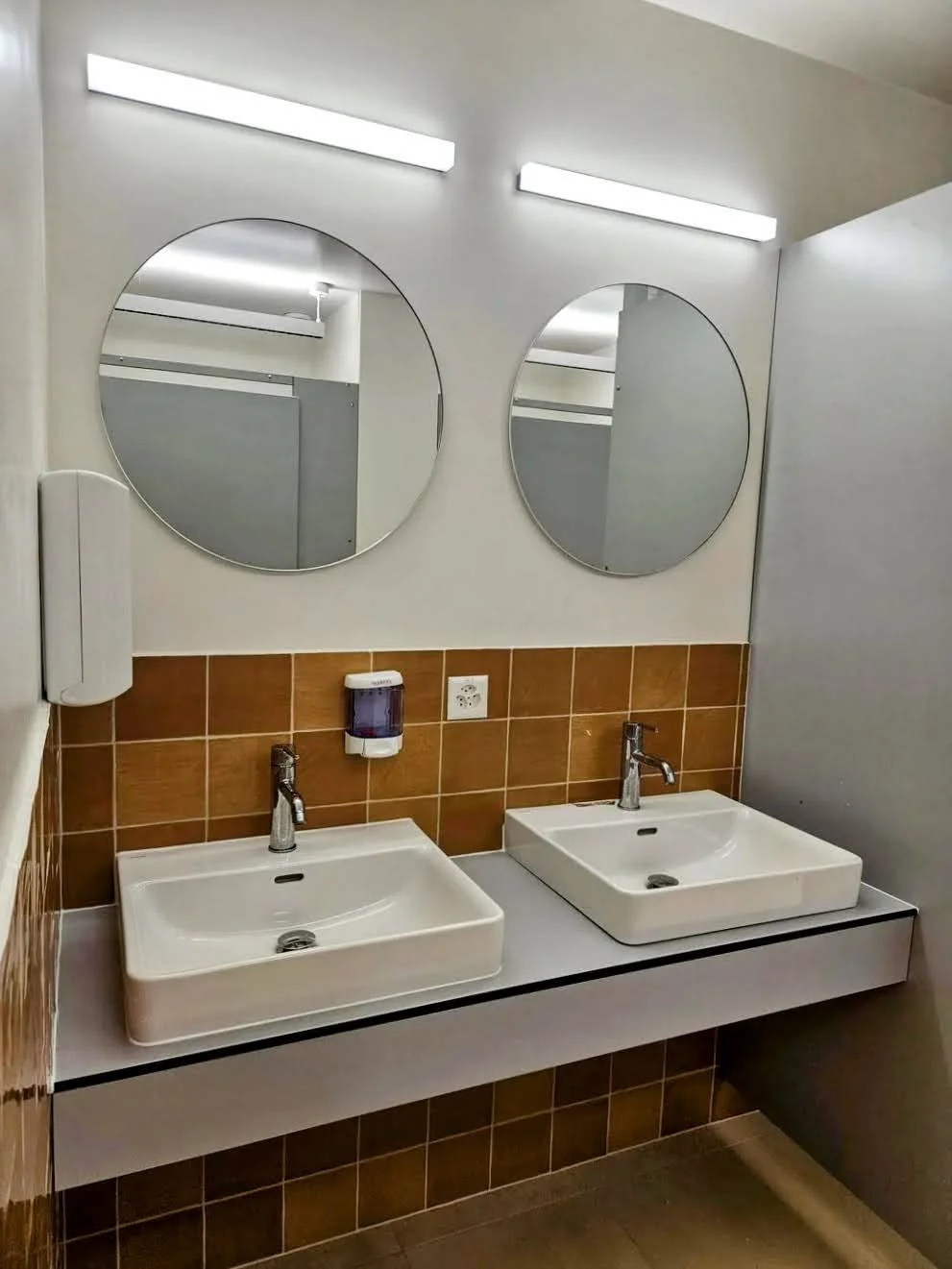 Public restroom mirror, sinks, soap dispenser